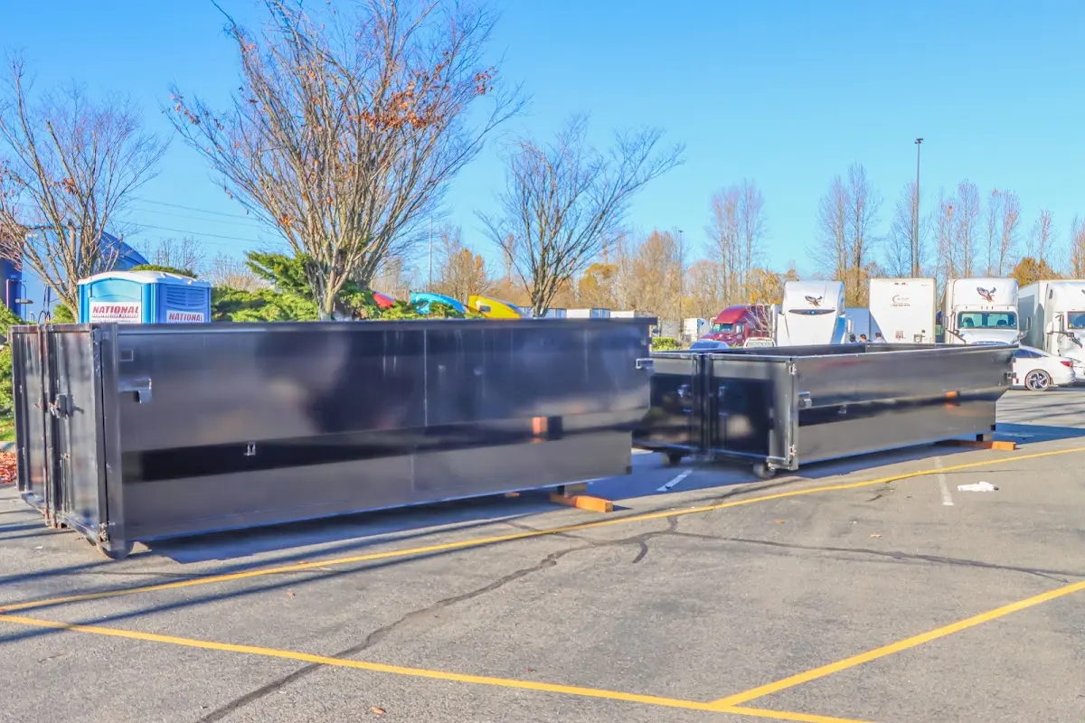 Professional dumpster rental service with roll-off container on residential driveway in Carroll